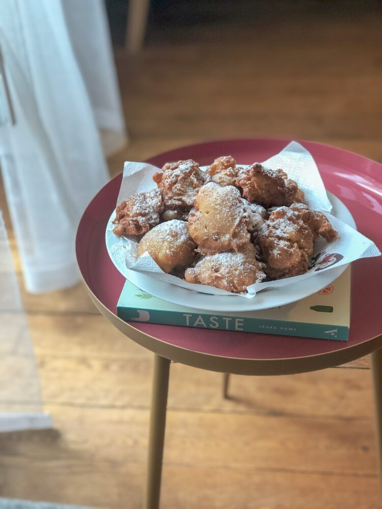 Apple fried fritters on a book on a table