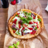 Sourdough gluten free pizza with anchovies, mozzarella and greens
