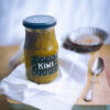 Spicy kiwi jam jar on a board